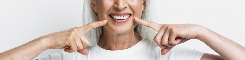 aged woman smiling after getting teeth