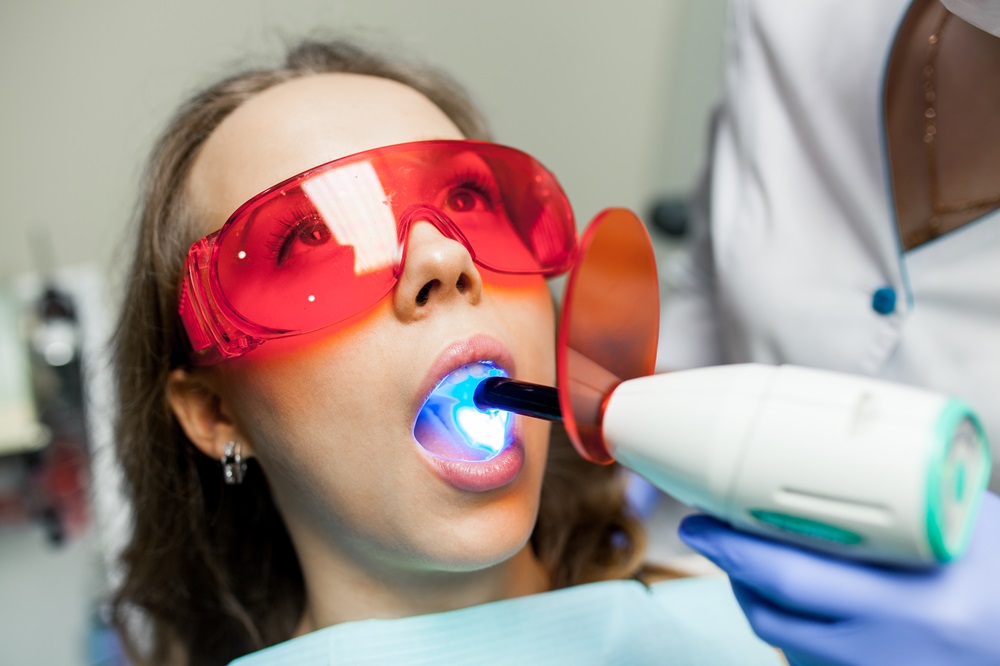 woman taking teeth whitening treatment